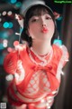 A woman in a red and white outfit is posing for a picture.