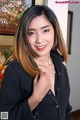 A woman in a black shirt posing for a picture.