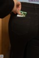 A person holding a credit card in their back pocket.