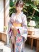 A woman in a kimono posing for the camera.