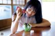 A woman sitting at a table with a bowl of food.