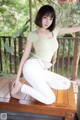 A woman sitting on top of a wooden table.