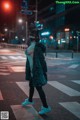 A woman wearing a mask standing in the middle of a street.